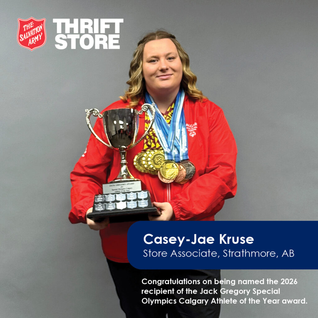 Casey-Jae Kruse Store Associate posting with olympic medals and holding a trophy